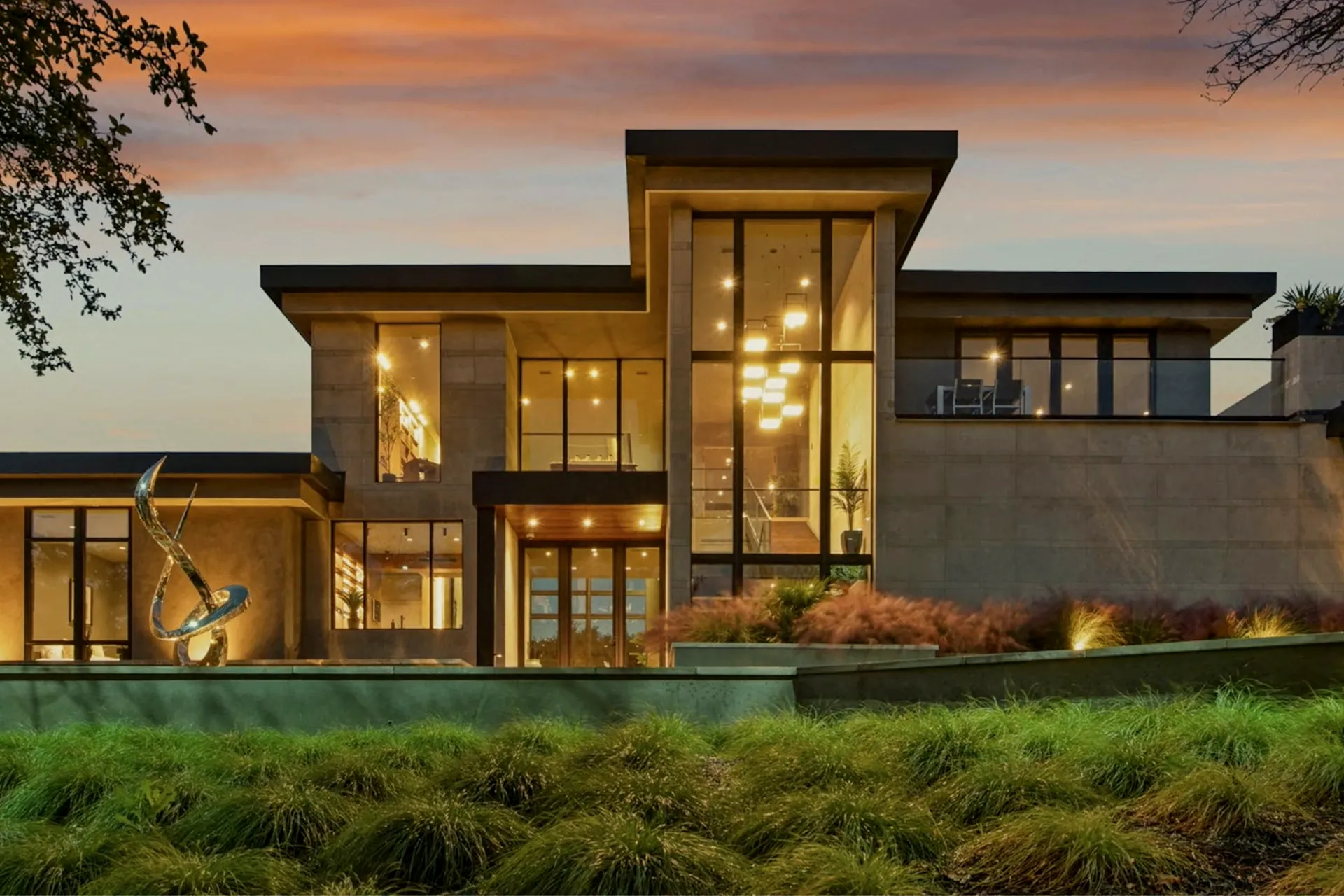Contemporary luxury home glowing golden at twilight