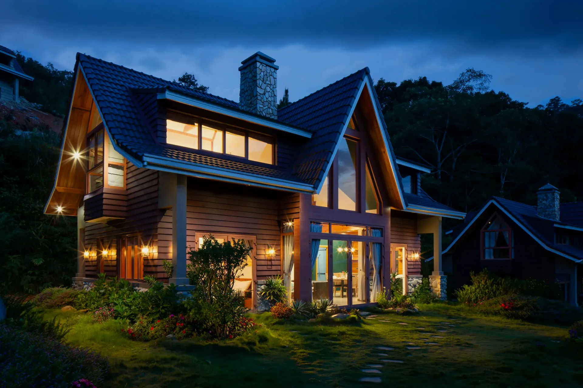 Private A-frame retreat with golden windows glowing at blue hour
